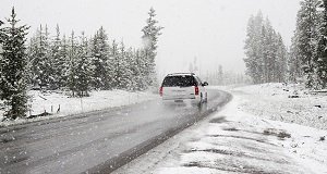 Car running on snow covered road