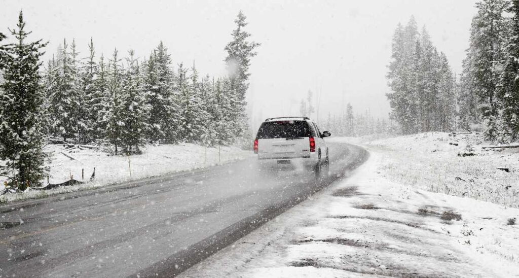 Car running on snow covered road