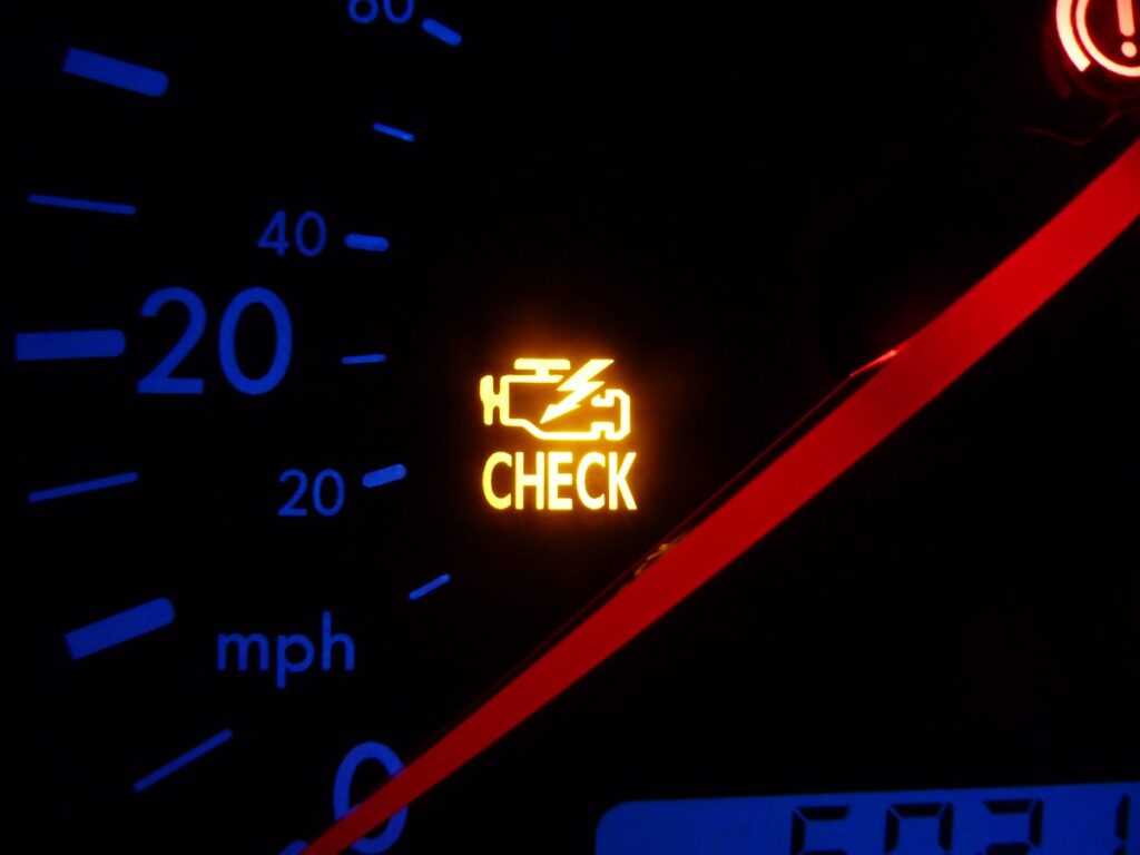 Dashboard showing a check engine light illuminated on a car's instrument panel.