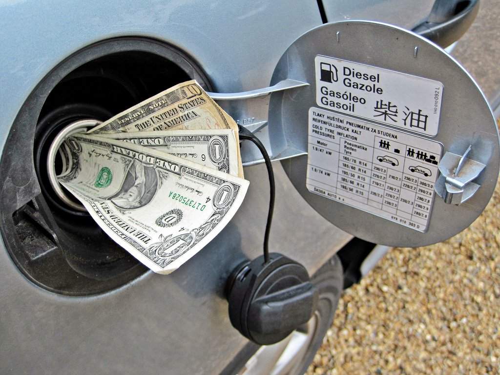 A dollar bill stuffed in a car's fuel tank.
